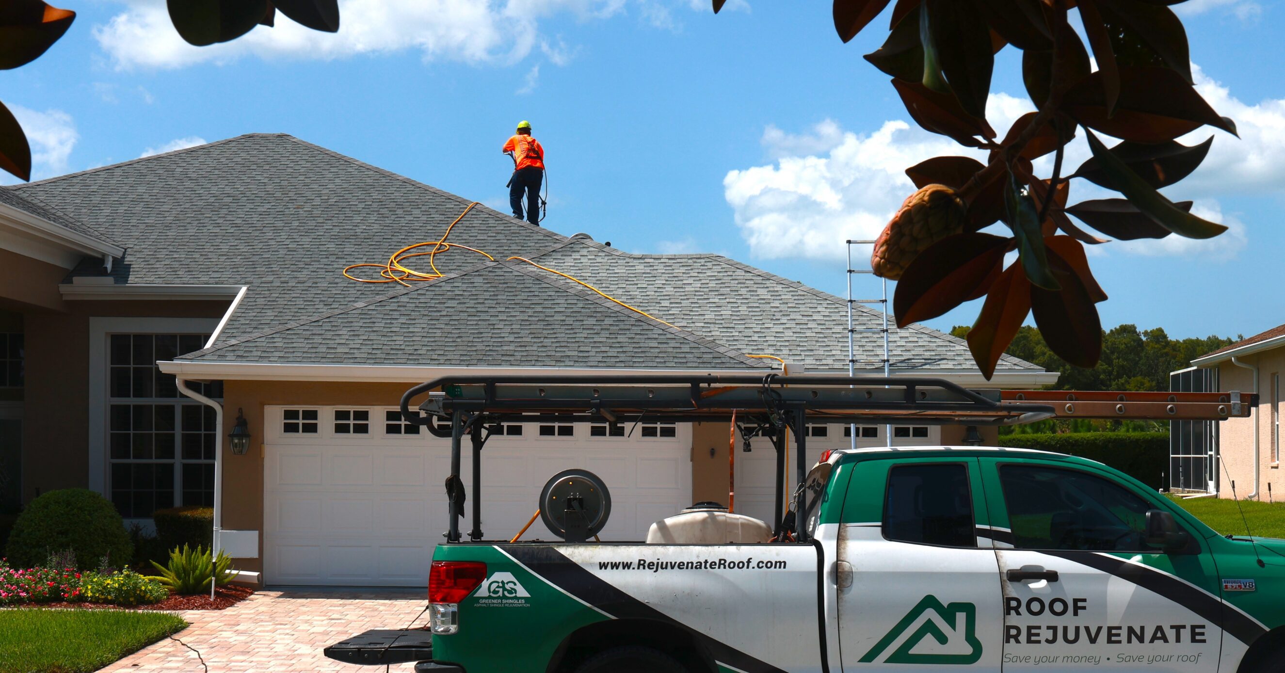 Roofer on house roof with service truck promoting home maintenance and roof rejuvenation